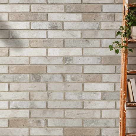 AI-styled interior detail with London Brick Fog 60x250mm brick-look porcelain wall tiles beside a timber ladder and plant