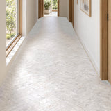 Matera Luna White 60x250mm stone look subway tiles in a herringbone hallway floor with natural daylight, design illustration