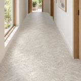 Matera Terra Greige 60x250mm stone look subway tiles in a herringbone hallway floor with natural daylight, design illustration