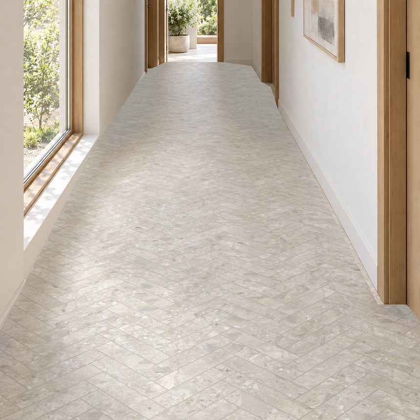 Matera Terra Greige 60x250mm stone look subway tiles in a herringbone hallway floor with natural daylight, design illustration
